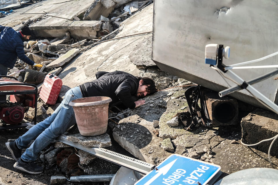 A man puts his ear to the rubble searching for the noise of any trapped person. People ask for more help in the Antakya district of Hatay, one of the cities where the biggest debris was experienced.<span class="copyright">Murat Kocabas—SOPA Images/LightRocket/Getty Images</span>