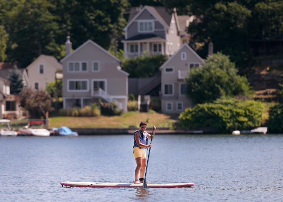 A paddleboarder on Lake Quinsigamond on Monday.