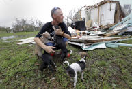 <p>Sam Speights tries to hold back tears while holding his dogs and surveying the damage to his home in the wake of Hurricane Harvey, Aug. 27, 2017, in Rockport, Texas. (Photo: Eric Gay/AP) </p>