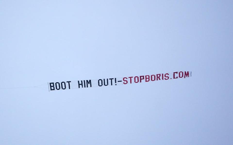 A sign protesting against Prime Minister Boris Johnson is flown over Manchester United’s Premier League match with West Ham at Old Trafford, Manchester (PA) (PA Wire)