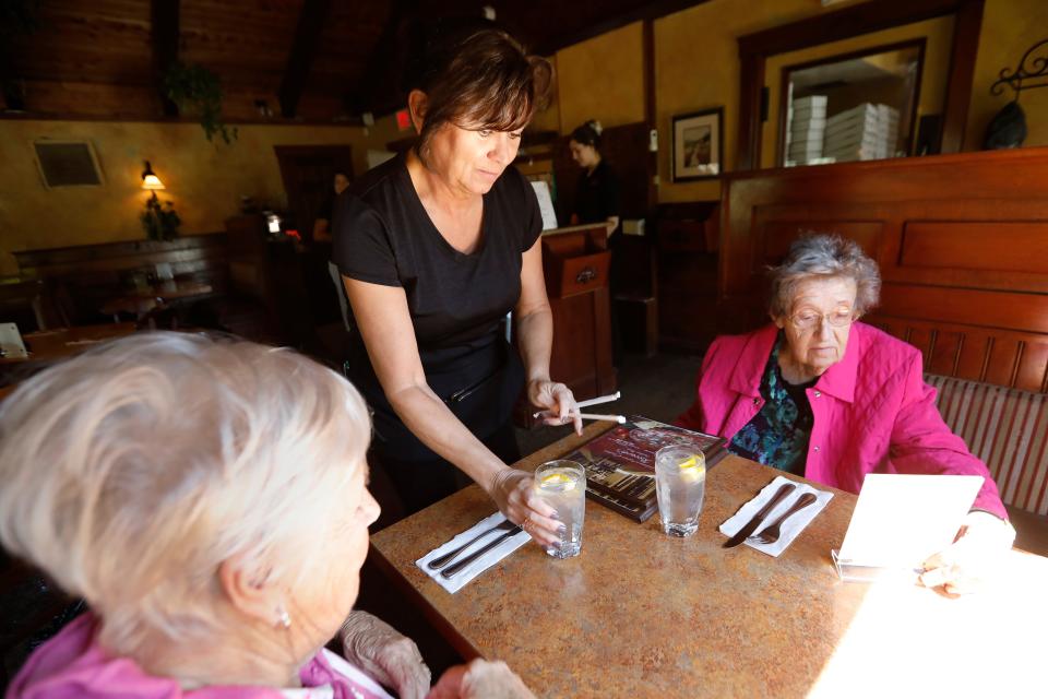 Renee Laflamme starts Lois Macomber and Janet Marlowe's lunch with two glasses of water at Riccardi's Restaurant on Hathaway Road in New Bedford.