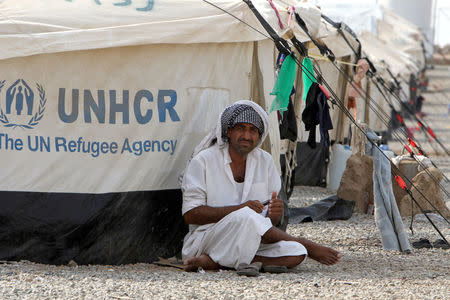 A man, who fled from the Islamic State violence, sits outside a tent at Debaga Camp in the Makhmour area near Mosul, Iraq, August 30, 2016. REUTERS/Azad Lashkari