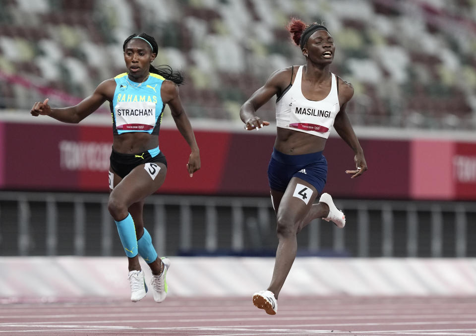 Anthonique Strachan, of Bahamas and Beatrice Masilingi, of Namibia compete in a women's 200-meter semifinal at the 2020 Summer Olympics, Monday, Aug. 2, 2021, in Tokyo, Japan. (AP Photo/Martin Meissner)