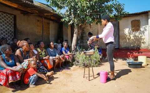 Lilian Sakala a community volunteer demonstrates proper hand-washing techniques while teaching hygiene practices to community members in zone three of Chipata Compound. Lusaka, Zambia, May 2018. - Credit: Chileshe Chanda/WaterAid