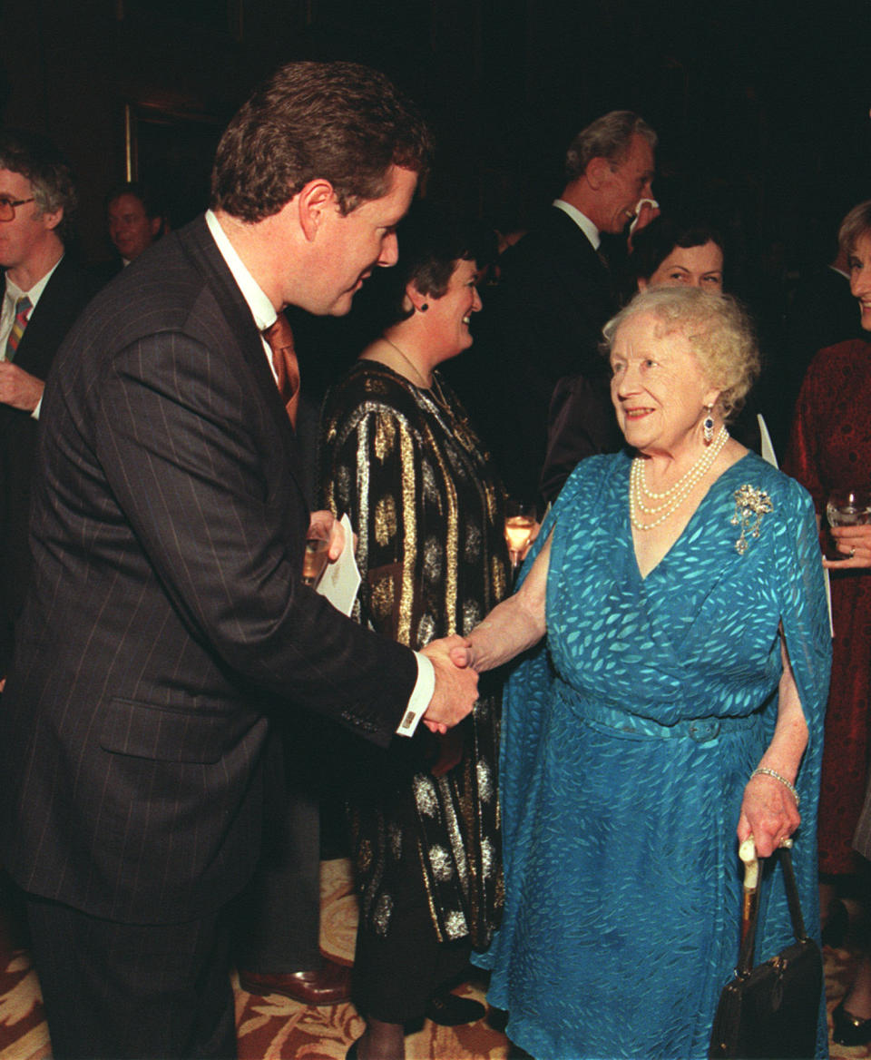 Piers Morgan chatting with the Queen Mother at Prince Philip’s 50th birthday party. Source: Getty