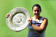 France's Marion Bartoli with the trophy after beating Germany's Sabine Lisicki during day twelve of the Wimbledon Championships at The All England Lawn Tennis and Croquet Club, Wimbledon.