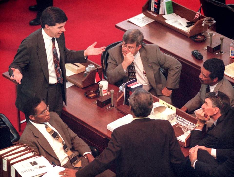 N.C. State Senator Roy Cooper, left, talks with House members, clockwise from left, Rep. Bob Hensley, Rep. Howard Hunter, Rep. Joe Hackney, Rep. Mickey Michaux, and Rep. Dan Blue in May 1998. Sen. Cooper and Rep. Ed McMahan are pushing a joint House-Senate redistricting plan.