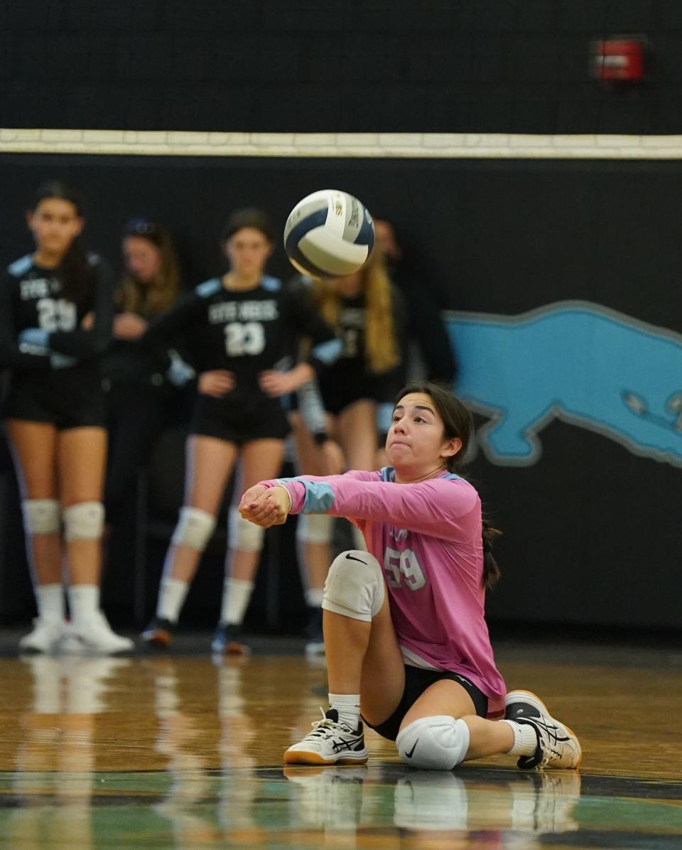 Rye Neck libero Gabriella Fasolino (59) digs a serve during their 3-1 win over Hastings in the opening round of Class B volleyball playoffs at Rye Neck High School in Rye Neck on Thursday, October 27, 2022.