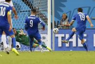 Greece's Sokratis Papastathopoulos (R) shoots the ball to score a goal against Costa Rica during their 2014 World Cup round of 16 game at the Pernambuco arena in Recife June 29, 2014. REUTERS/Yves Herman