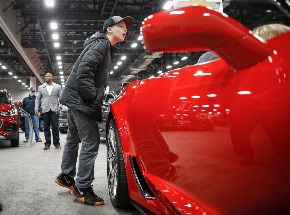 Jonas Bottenfield-Biehn, 12, of Des Moines looks into the inside of a Corvette during the Des Moines Register All Iowa Auto Show on Saturday, March 9, 2019, at the Iowa Events Center in Des Moines.