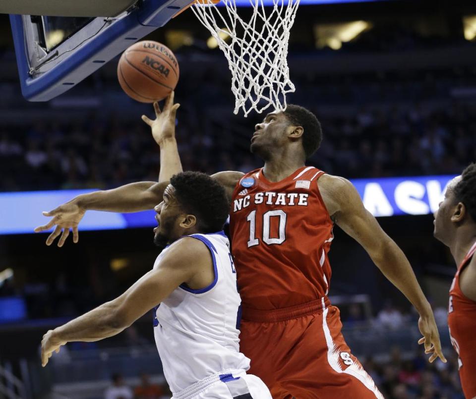 Saint Louis forward Dwayne Evans (21) drives to the basket as North Carolina State forward Lennard Freeman (10) defends during the first half of a second-round game in the NCAA college basketball tournament Thursday, March 20, 2014, in Orlando, Fla. Evans maked the shot. (AP Photo/John Raoux)