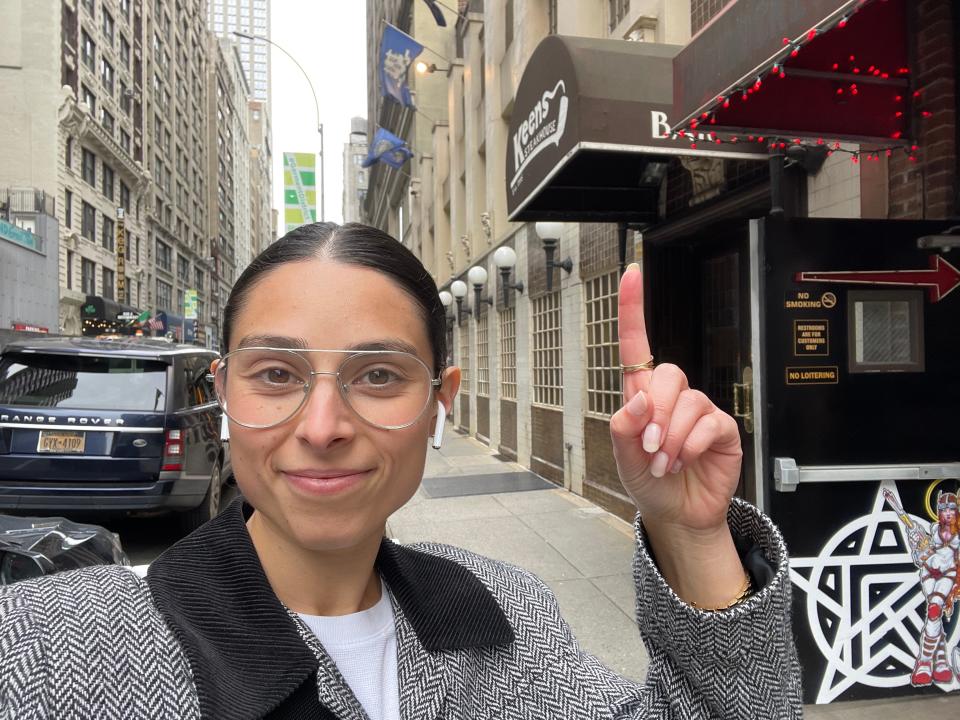 Author Rachel Askinasi pointing to Keens steak house