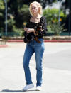 <p>Amber Valletta adds a bit of spring to her outfit, wearing a floral top and white sneakers on Monday in L.A.</p>