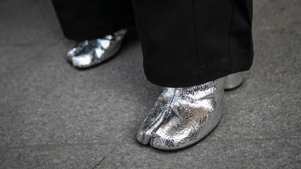 Choi Heui-seung (also pictured top) wears a pair of metallic-colored Maison Margiela boots. - Jean Chung/Getty Images