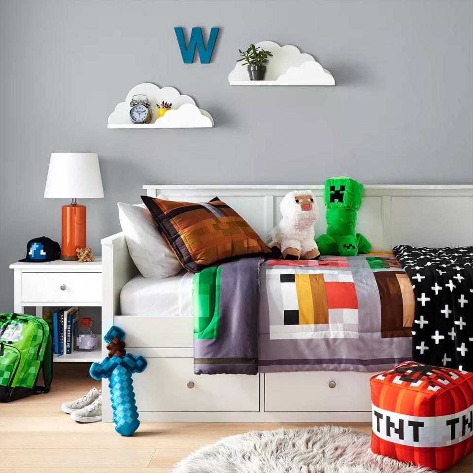 Cloud-shaped shelves on wall above child's bed