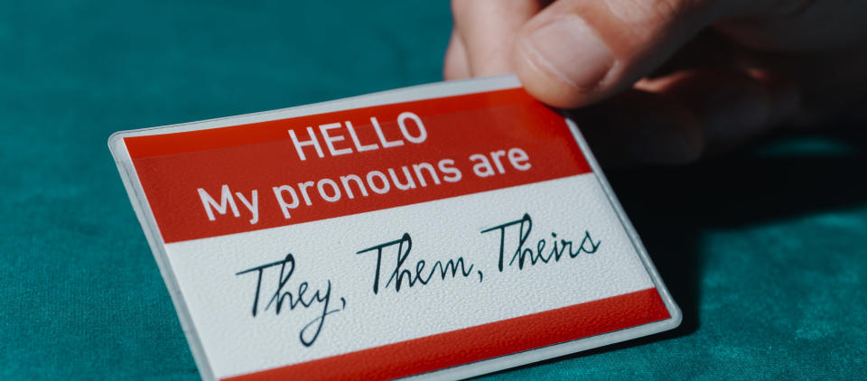 a name tag with they, them, theirs pronouns