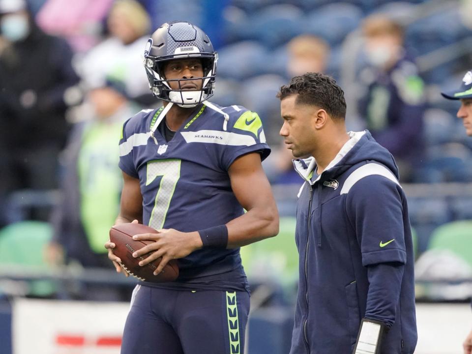 Geno Smith and Russell Wilson prepare for a game against the New Orleans Saints.