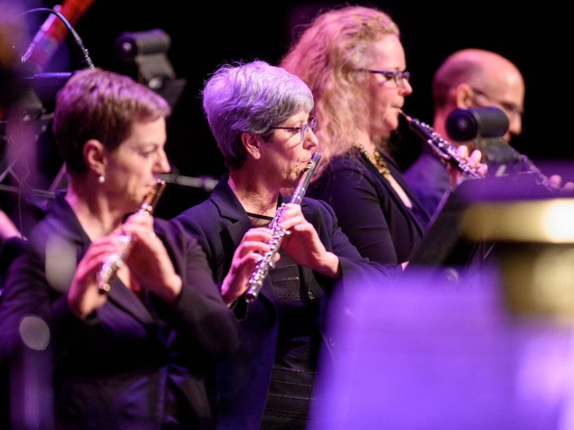 Randi Nelson, second from left, was principal flutist with the Saskatoon Symphony Orchestra for 40 years. She died of cancer in 2020.  (Saskatoon Symphony Orchestra. - image credit)