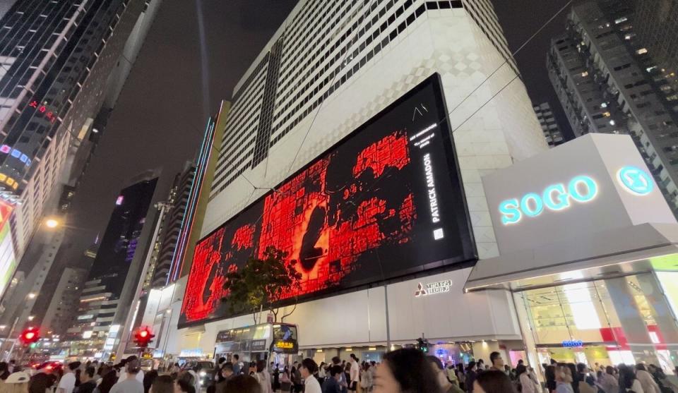 In this undated image released by Art Innovation Gallery, Patrick Amadon's "No Rioters" digital artwork is seen on the billboard of the SOGO shopping mall in Hong Kong. The Hong Kong department store took down a digital artwork that contained hidden references to jailed dissidents, in an incident the artist says is evidence of erosion of free speech in the semi-autonomous Chinese city. (Art Innovation Gallery via AP)