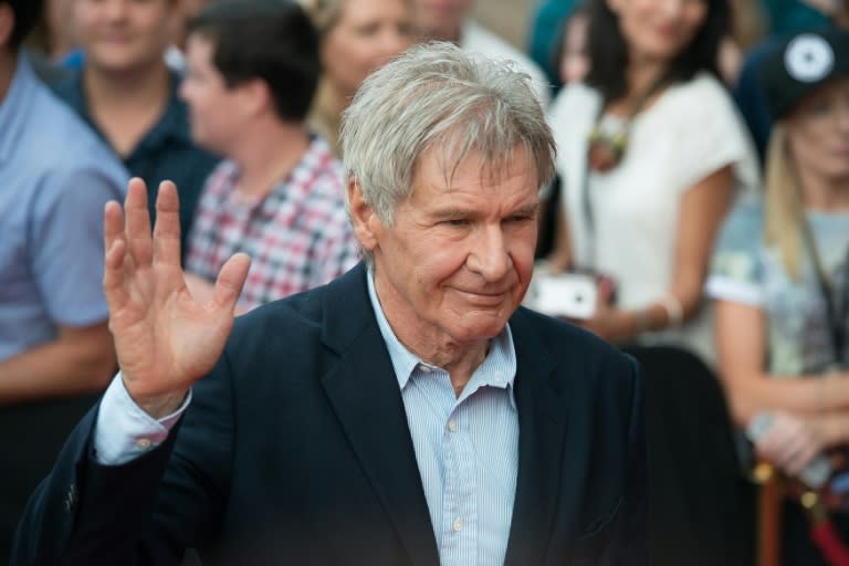 Actor Harrison Ford waves to fans as he arrives for a Star Wars promotional event at the Sydney Opera House on December 10, 2015