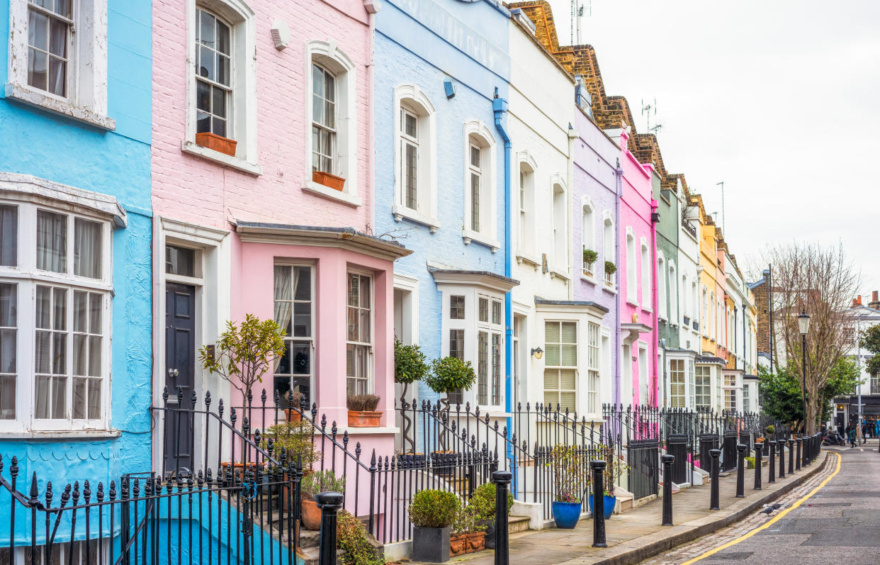 A street in the Chelsea area of central London, with each house painted a different pastel colour.