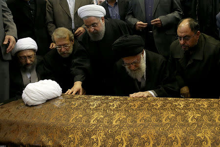 Iran's Supreme Leader Ayatollah Ali Khamenei and Iran's President Hassan Rouhani touch the coffin of former president Ali Akbar Hashemi Rafsanjani during his funeral ceremony in Tehran, Iran January 10, 2017. Leader.ir/Handout via REUTERS