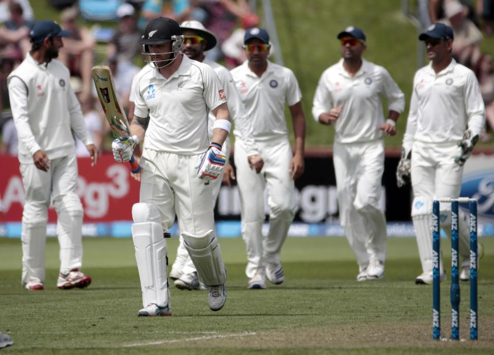 India's players celebrate the dismissal of New Zealand's Brendon McCullum (2nd L) during day one of the second international test cricket match at the Basin Reserve in Wellington, February 14, 2014. REUTERS/Anthony Phelps (NEW ZEALAND - Tags: SPORT CRICKET)