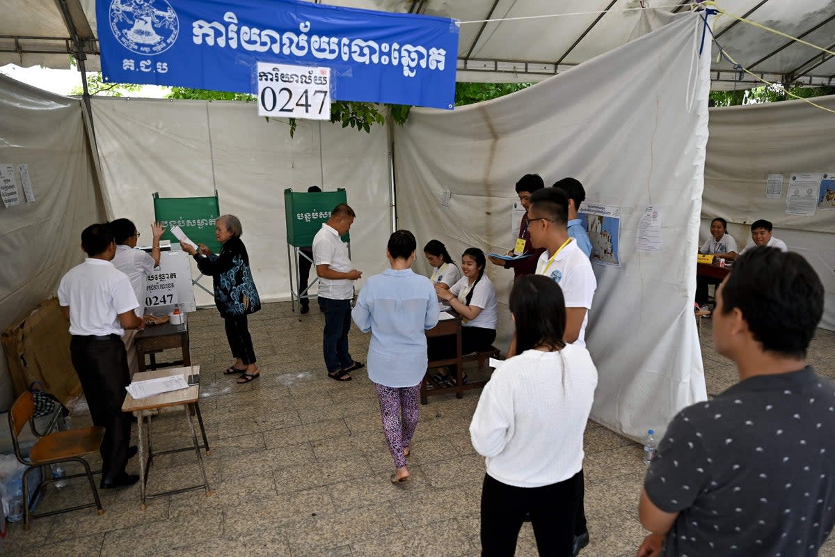 People line up to cast their votes at a polling station in Phnom Penh on 23 July, 2023 during the general elections (AFP via Getty Images)