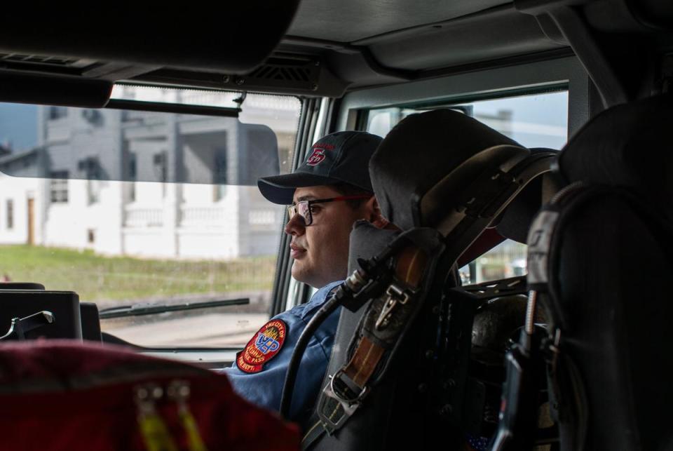 Firefighter EMT Carlos Rodriguez sits in the passenger seat of a fire truck responding to a motor vehicle accident in downtown Eagle Pass becuase all five ambulances were already dispatched to other incidents on Feb. 29, 2024.