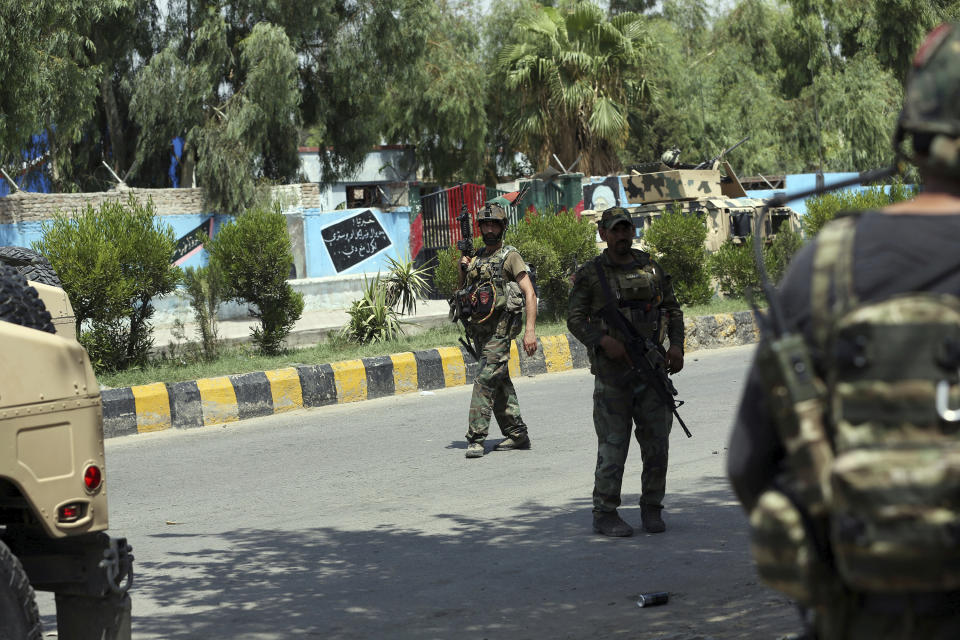 Afghan security personnel gather near a prison after an attack in the city of Jalalabad, east of Kabul, Afghanistan, Monday, Aug. 3, 2020. An Islamic State group attack on the prison in eastern Afghanistan holding hundreds of its members raged on Monday after killing people in fighting overnight, a local official said. (AP Photo/Rahmat Gul)