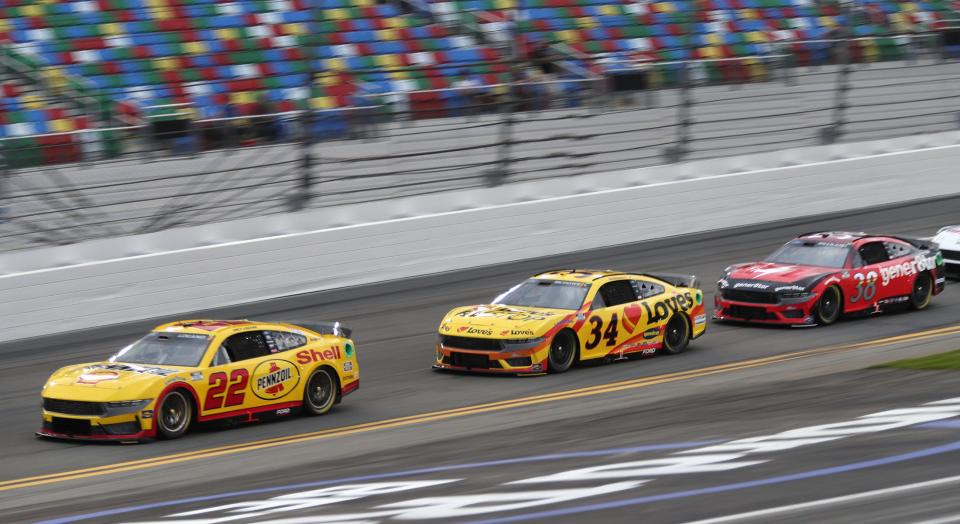 Joey Logano (22) and Michael McDowell (34) will start on the front row in new Ford Mustangs.