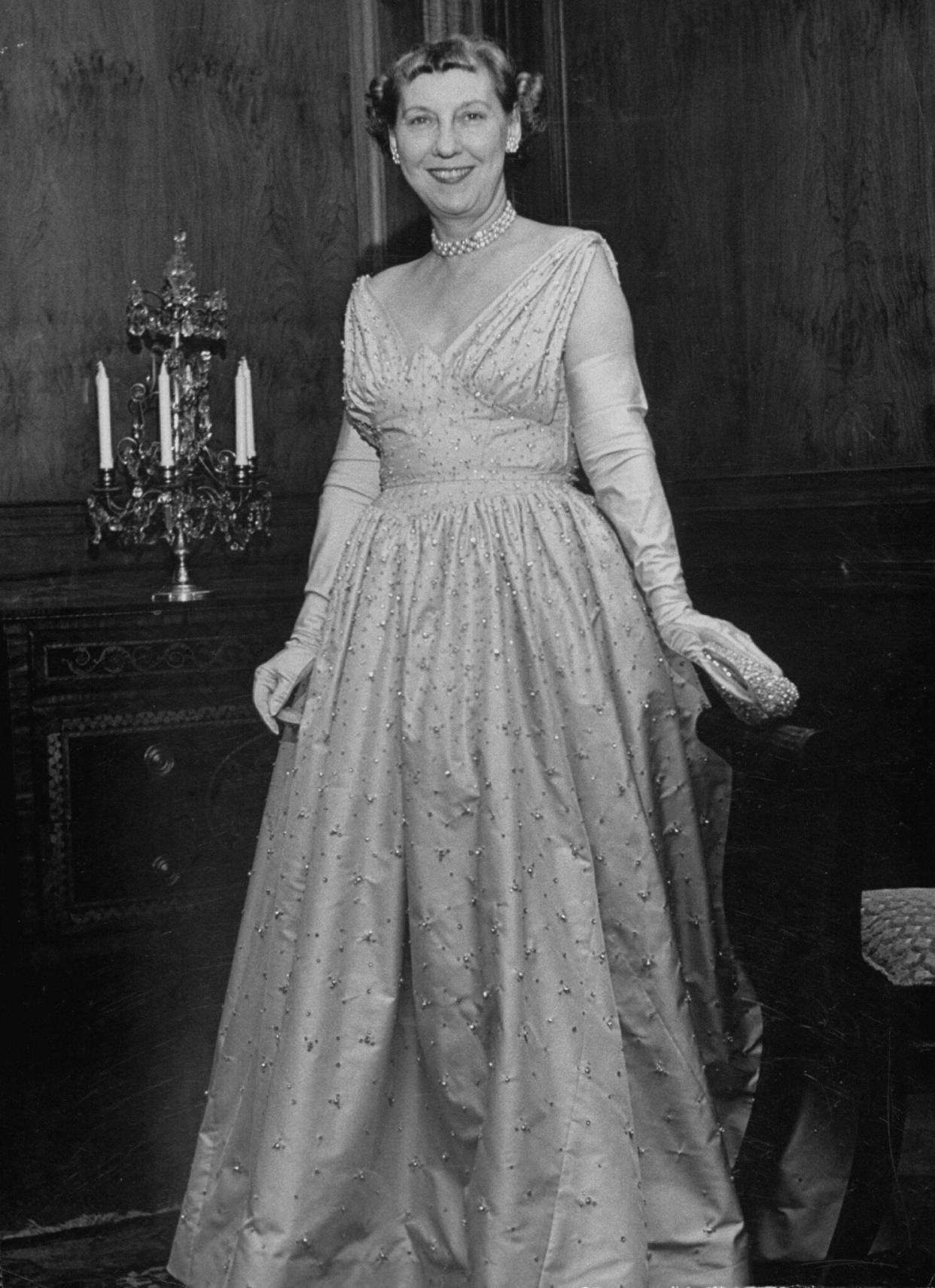 Mamie Eisenhower shows off the gown she wore for inaugural balls in 1953.