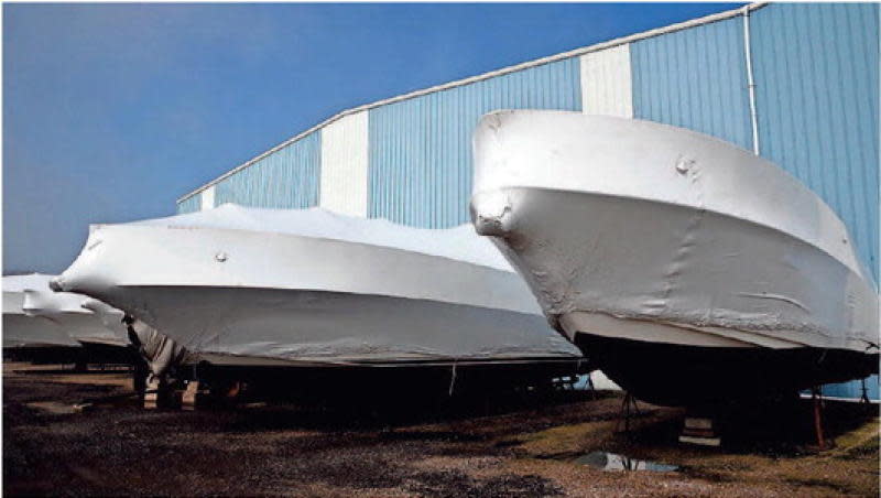 Shrink-wrapped boats are shown last April at the Monroe Boat Club.