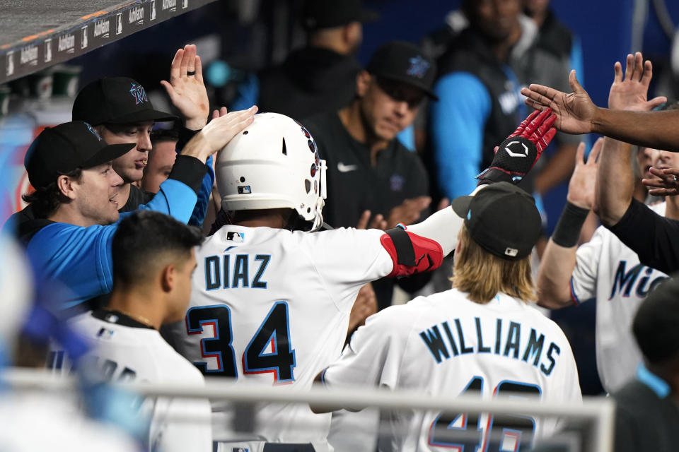 Miami Marlins' Lewin Diaz (34) is congratulated after hitting a solo home run against the Chicago Cubs during the fifth inning of a baseball game Wednesday, Sept. 21, 2022, in Miami. (AP Photo/Lynne Sladky)