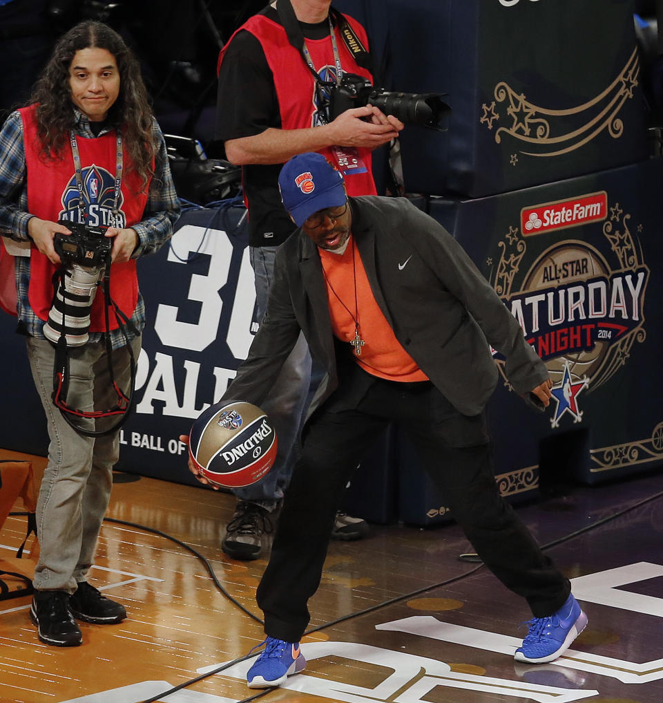 Director Spike Lee grabs a loose ball during the skills competition at the NBA All Star basketball game, Saturday, Feb. 15, 2014, in New Orleans. (AP Photo/Bill Haber)