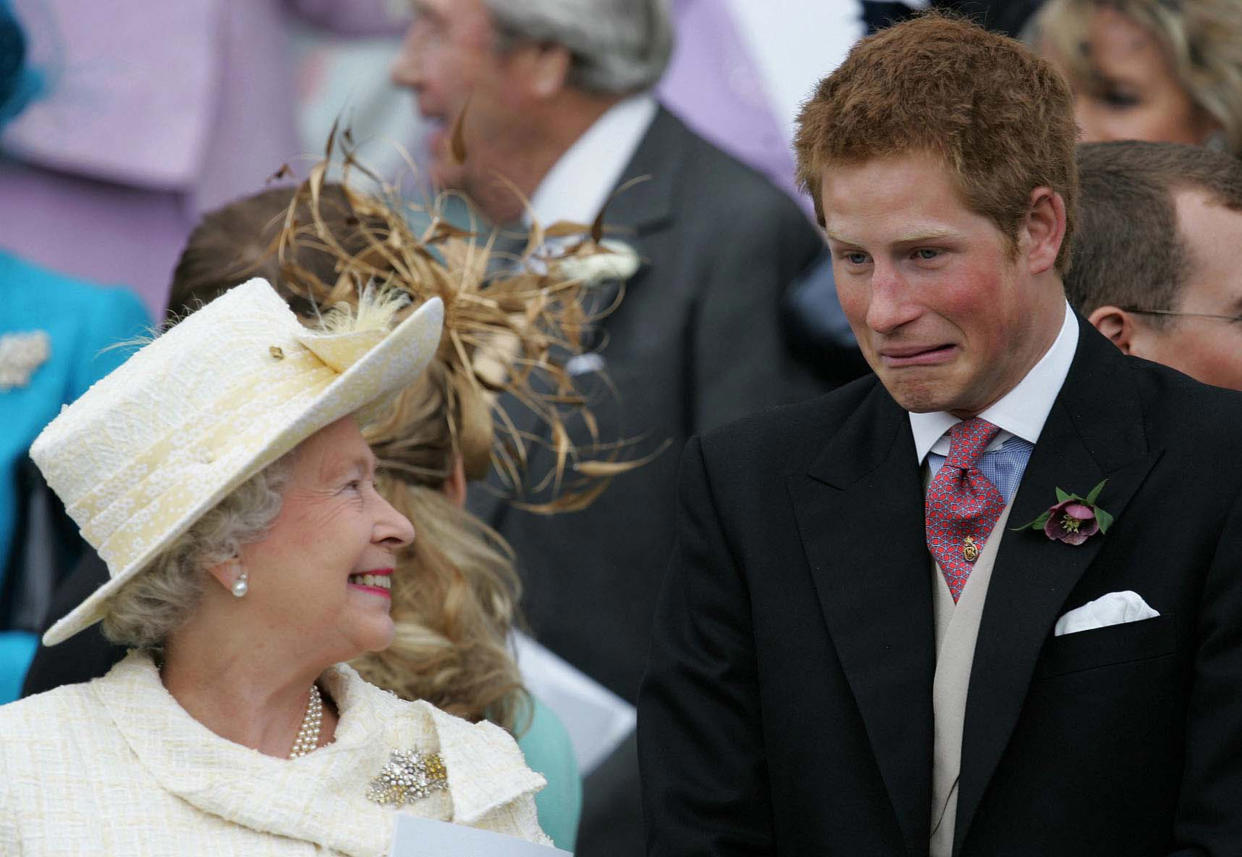 Britain's Queen Elizaberth II smiles as Prince Harry pulls a face as they watch Prince Charles and Camilla, Duchess of Cornwall leave St. George's Chapel.  Britain's Queen Elizaberth II smiles as Prince Harry pulls a face as they watch Prince Charles and Camilla, Duchess of Cornwall leave St. George's Chapel in Windsor Castle April 9, 2005. Prince Charles finally married the love of his life on Saturday, in a simple town hall ceremony contrasting sharply with his spectacular cathedral wedding to the ill-fated Princess Diana. REUTERS/Alastair Grant/AP WPA PICTURES OF THE YEAR 2005