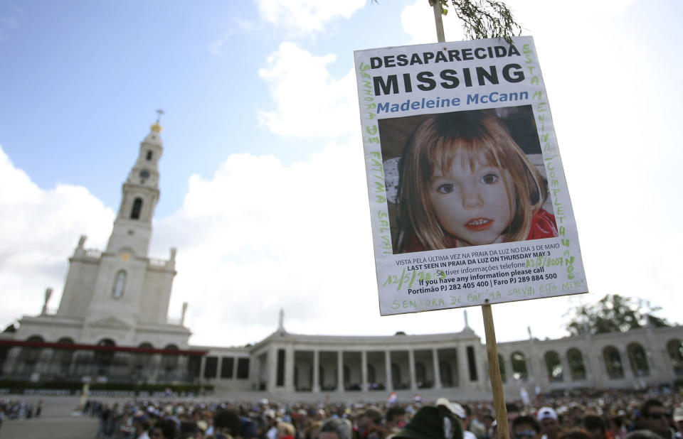 FILE - A picture of missing British girl Madeleine McCann, who disapeared from the Praia da Luz beach resort in the Algarve, is displayed at Our Lady of Fatima shrine Sunday, May 13 2007, in Fatima, northern Portugal. The parents of Madeleine McCann, a British toddler who vanished from an apartment during her family’s vacation in Portugal 15 years ago and captured global interest, say they remain hopeful that efforts by police in three countries to solve the mystery will eventually bring answers. Kate and Gerry McCann, both British doctors living in England, said in a statement to mark the anniversary of their daughter’s disappearance Tuesday, May 3, 2022 that “a truly horrific crime” was committed in 2007. (AP Photo/Steven Governo, File)