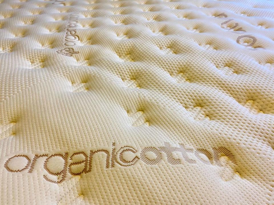 a closeup of the pillow top surface of a luxury firm saatva classic mattress