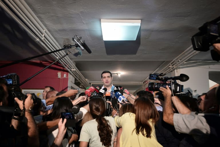 Greek radical-left Syriza party leader and former Prime Minister Alexis Tsipras talks to the press after casting his vote at a polling station in central Athens on September 20, 2015