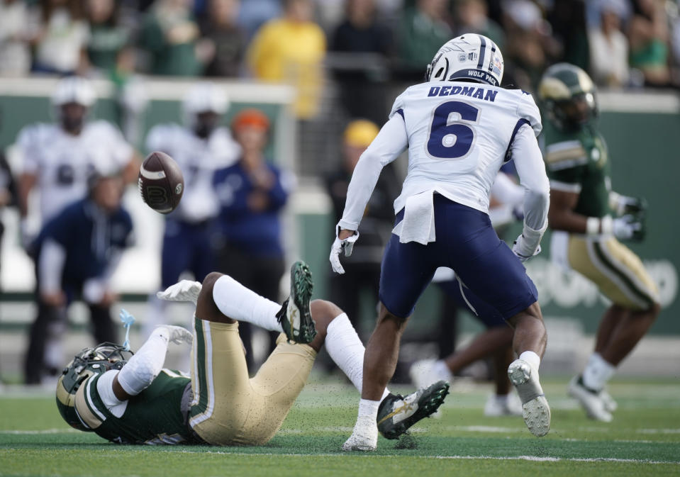 Colorado State wide receiver Tory Horton, left, loses control of the ball while trying to pull in a pass as Nevada defensive back Jaden Dedman (6) looks on in the first half of an NCAA college football game Saturday, Nov. 18, 2023, in Fort Collins, Colo. (AP Photo/David Zalubowski)