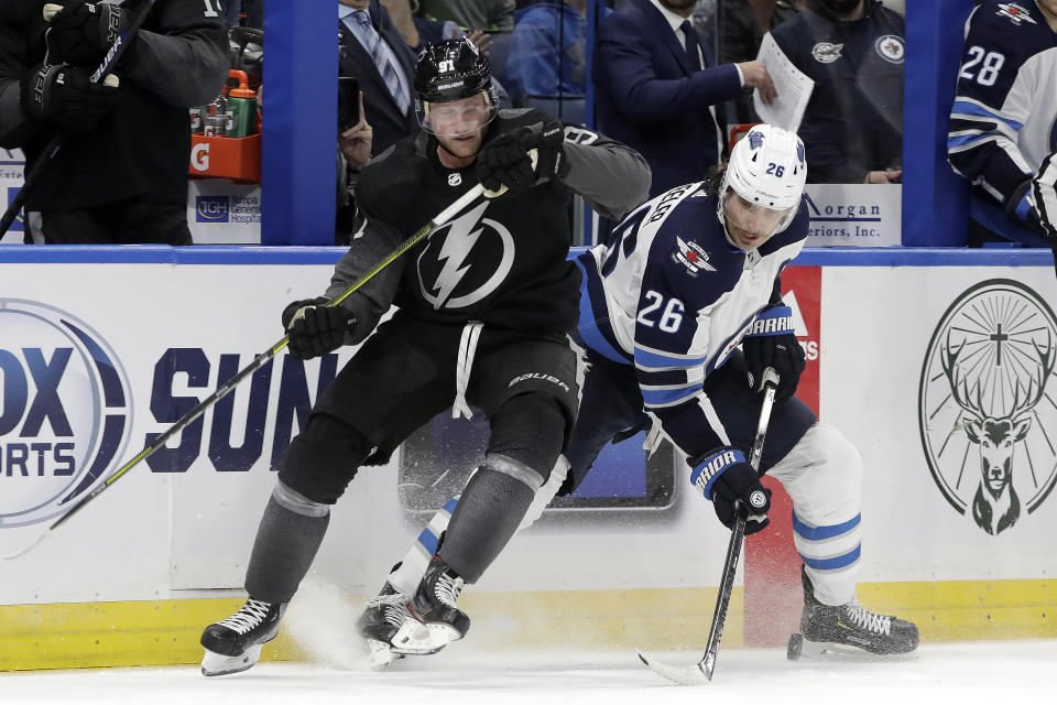 Winnipeg Jets right wing Blake Wheeler (26) strips the puck from Tampa Bay Lightning center Steven Stamkos (91) during the third period of an NHL hockey game Saturday, Nov. 16, 2019, in Tampa, Fla. (AP Photo/Chris O'Meara)