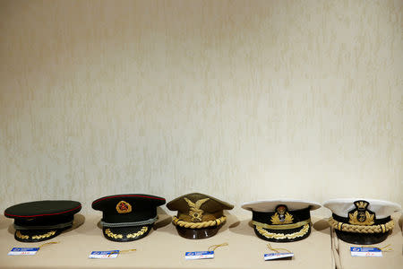 Military officer hats from various attending countries are lined up at the cloakroom at the Xiangshan Forum in Beijing, China October 25, 2018. REUTERS/Thomas Peter