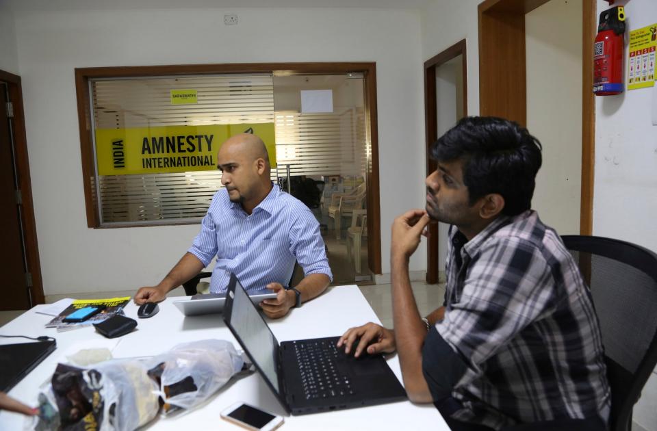 Amnesty International India employees work at their headquarters in Bangalore, India. (file photo) (AP)