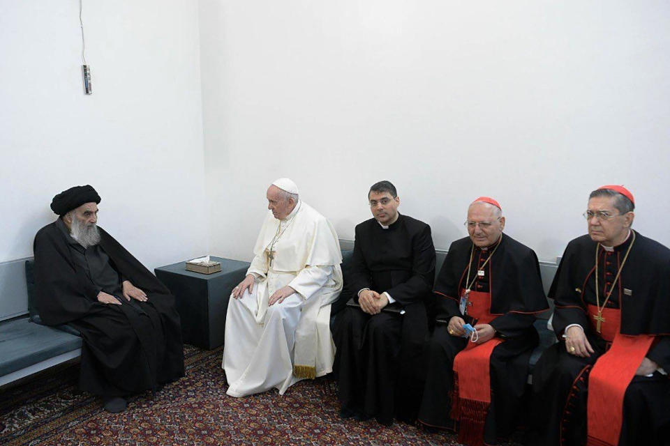 A photo released by the Grand Ayatollah Ali al-Sistani Office shows Shiite Muslim leader, Grand Ayatollah Ali al-Sistani, left, meeting Pope Francis, 2nd left, along with Christian priests in Najaf, Iraq, Saturday, March 6, 2021. Pope Francis arrived in Iraq on Friday to urge the country's dwindling number of Christians to stay put and help rebuild the country after years of war and persecution, brushing aside the coronavirus pandemic and security concerns to make his first-ever papal visit. (AP Photo/HO)