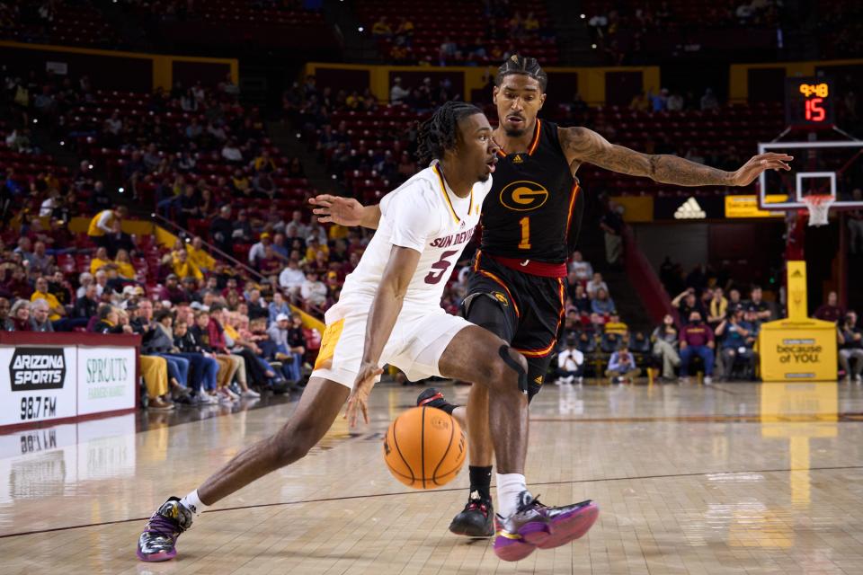 Arizona State Sun Devils sophomore forward Jamiya Neal (5) dribbles while being pressured by Grambling State Tigers graduate student guard Cameron Christon (1) at Desert Financial Arena on Tuesday, Nov. 22, 2022.