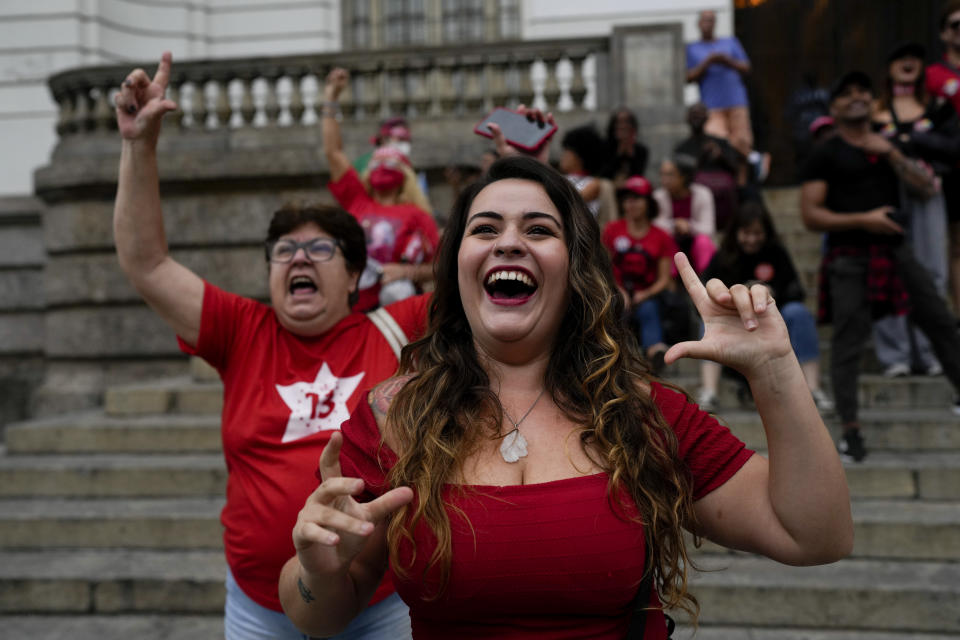 Followers of former Brazilian President Luiz Inacio "Lula" da Silva, who is running for president again, celebrate partial results after general election polls closed in Rio de Janeiro, Brazil, Sunday, Oct. 2, 2022. (AP Photo/Silvia Izquierdo)