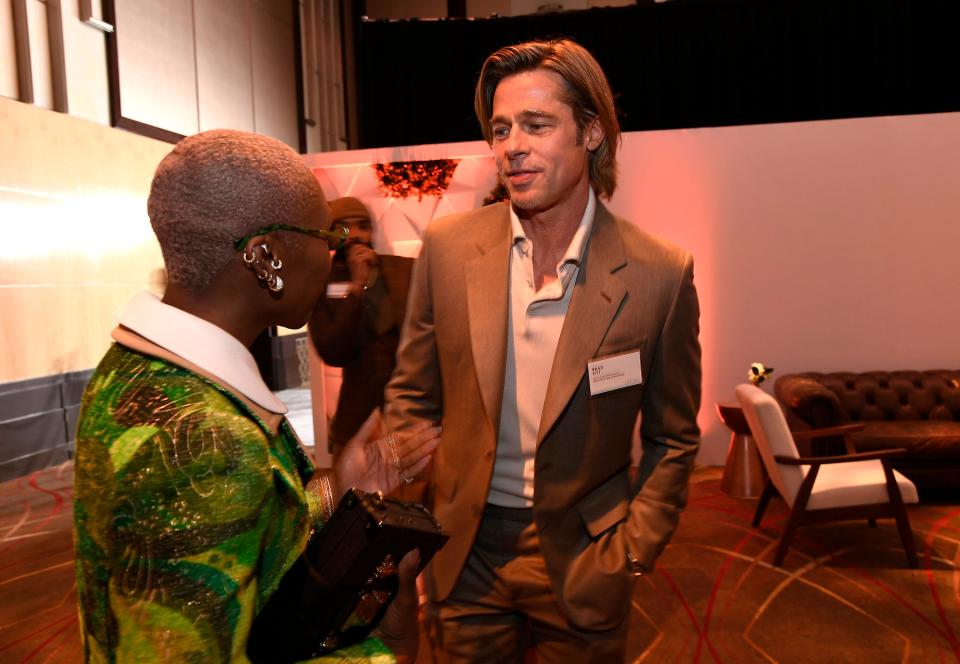 Yes, that's Brad Pitt in a name tag talking to Cynthia Erivo at the Oscars nominees luncheon.
