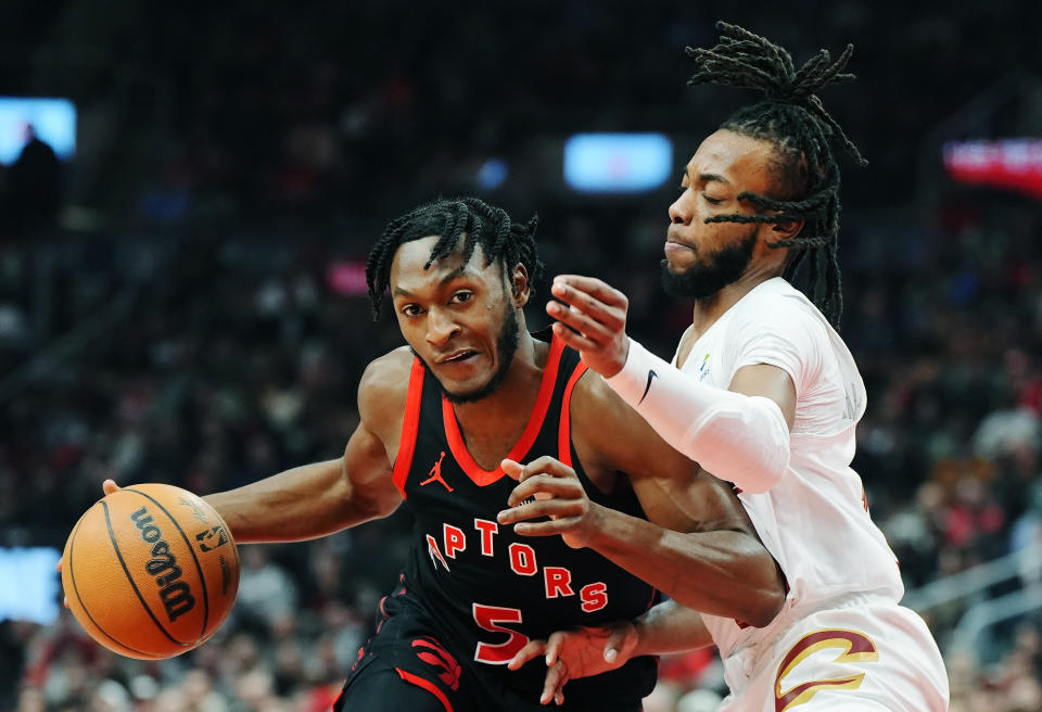 Toronto Raptors guard Immanuel Quickley (5) drives past Cleveland Cavaliers guard Darius Garland (10) during the first half of an NBA basketball game, Saturday, Feb. 10, 2024 in Toronto. (Frank Gunn/The Canadian Press via AP)