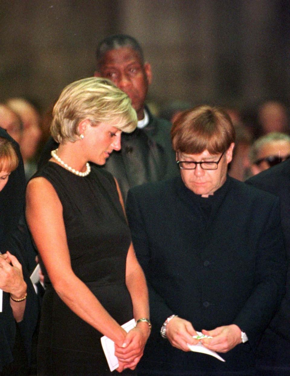 Princess Diana comforts Elton John&nbsp;during a mass for Italian fashion designer Gianni Versace in Milan, July 22.&nbsp;&nbsp; (Photo: Stefano Rellandini / Reuters)