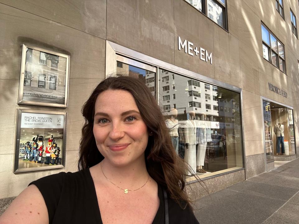 A selfie of a woman in front of an "ME+EM" store.